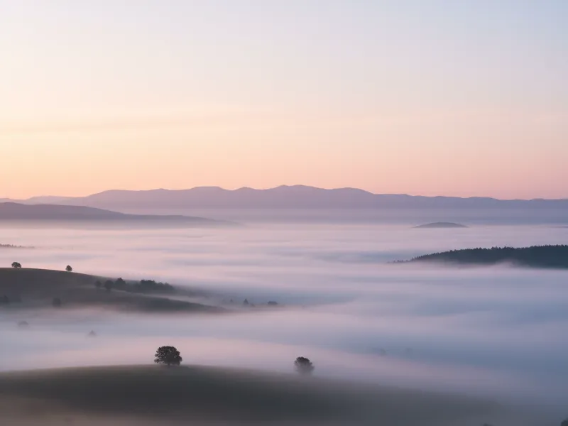 A card made by imanotes: fog filling a valley at sunrise
